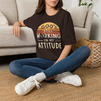 Christian T-Shirt — "God’s Still Working on My Attitude" Retro Sun Graphic